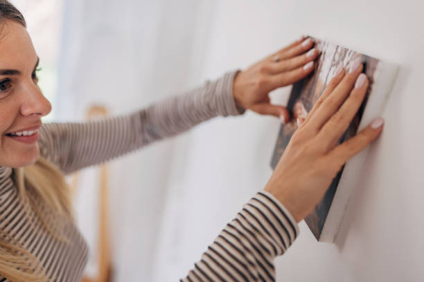 istock Decorating her wall with photograph 1316222442