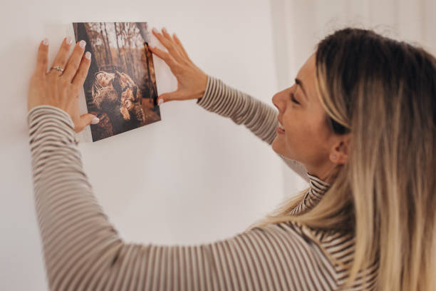 istock Lady decorating her wall with photograph 1316222459