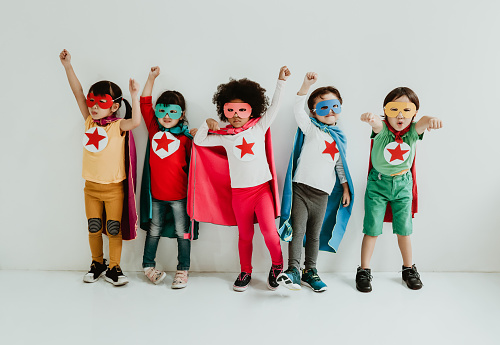 Group of Diverse Children Playing superhero on the white wall background. Superhero concept. Happy Time.