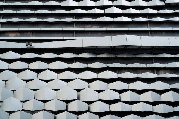 istock modern Aluminium composite material architecture gray color and Hexagon shape popup texture on exterior facade building. 1316225774