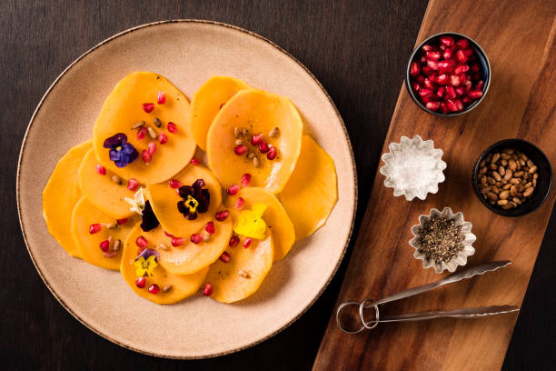 istock Plate of Sliced Butternut Squash with Pine Nuts  and Pomegranate Seeds 1316225958