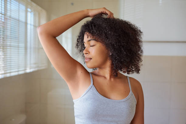 Shot of a beautiful young woman smelling her underarms at home I feel fresh and smell it too underarm stock pictures, royalty-free photos & images