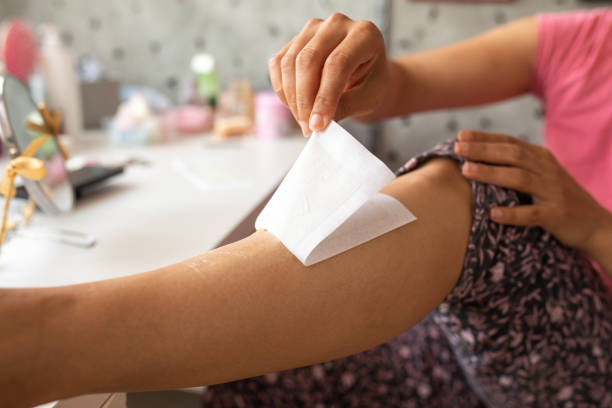 istock Woman waxing her legs while relaxing at home during weekend 1316232778