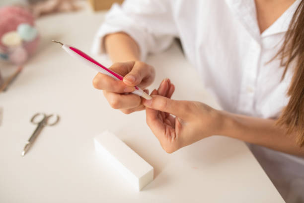 istock Young woman doing manicure treatment at home 1316233690