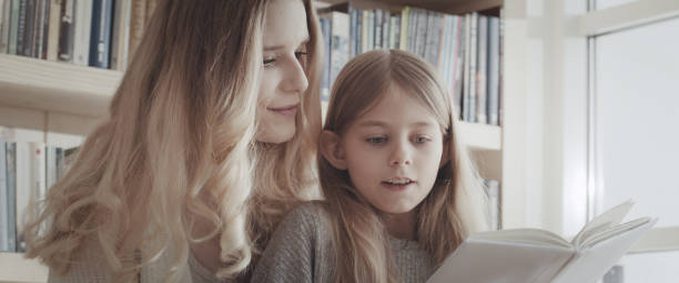 istock Caring mother reading book with her little daughter 1316235363