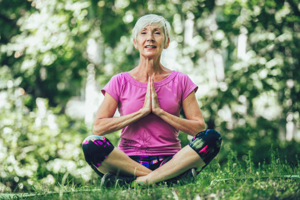 istock Happy mature woman practicing yoga in park. Active lifestyle 1316235629