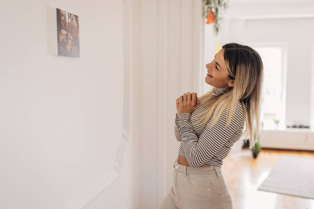 istock Woman looking at photograph on the wall 1316237166