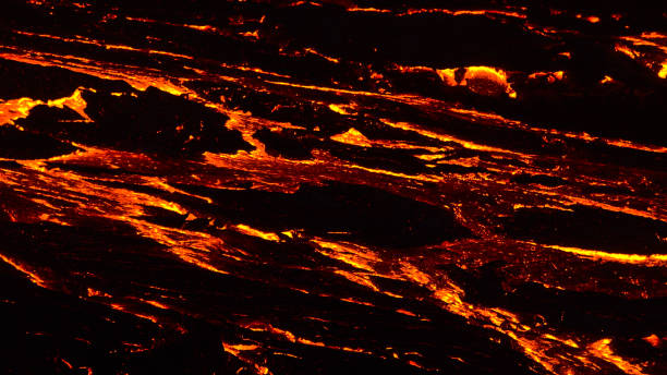 Breathtaking close-up view of flow of glowing lava at volcano eruption site in Geldingadalir valley near Fagradalsfjall mountain, Grindavík, Reykjanes, Iceland in the dark. stock photo