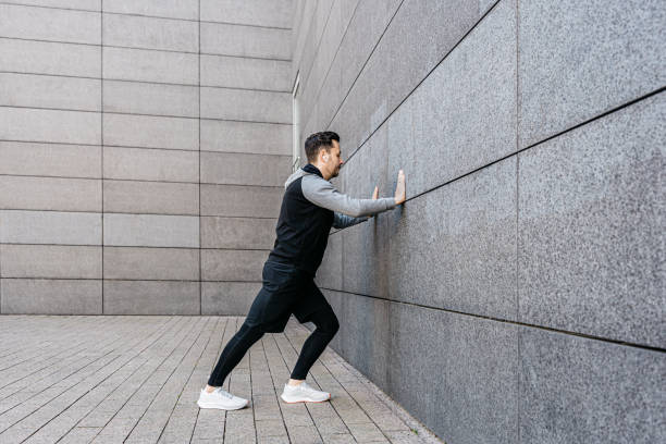 istock Man stretching on a gray concrete wall before jogging 1316241299