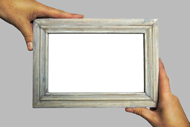 istock A person is holding a empty old wooden picture frame 1316241537