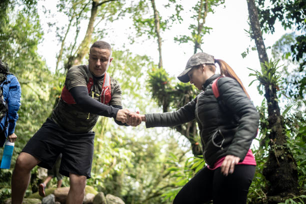 istock Holding friend's hand to assist during hiking 1316243300