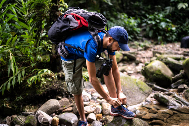 istock Man tying his shoes during hiking 1316243312