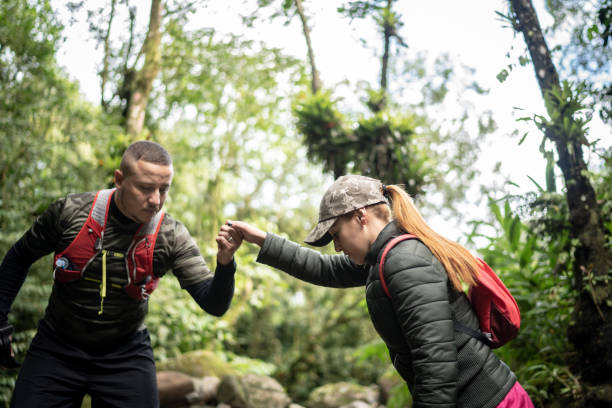 istock Holding friend's hand to assist during hiking 1316243316