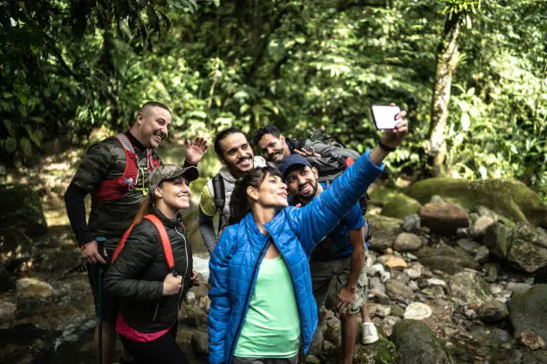 Photo of Friends taking a selfie or filming during hiking