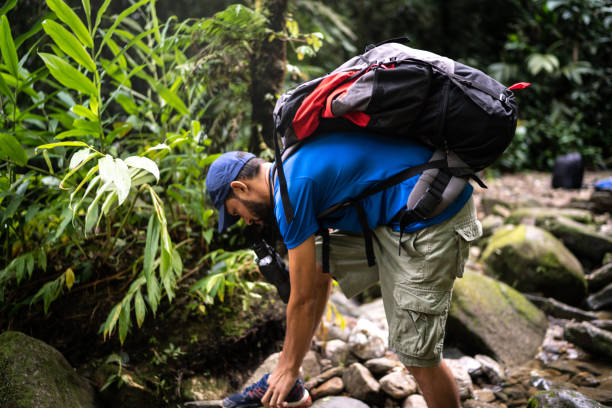 istock Man tying his shoes during hiking 1316243376