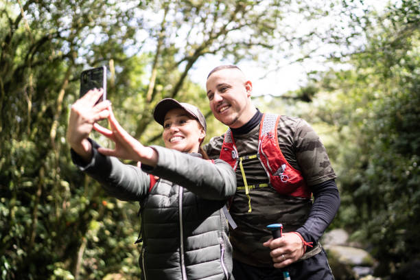 istock Couple taking a selfie or filming during hiking 1316243379