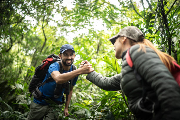 istock Holding friend's hand to assist during hiking 1316243388