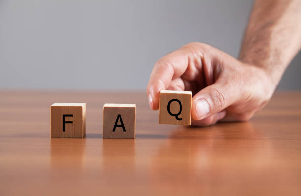 istock Hand putting wooden cube block with word FAQ. 1316244110