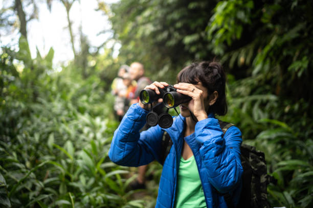 istock Young woman usng binoculars during hiking 1316244206