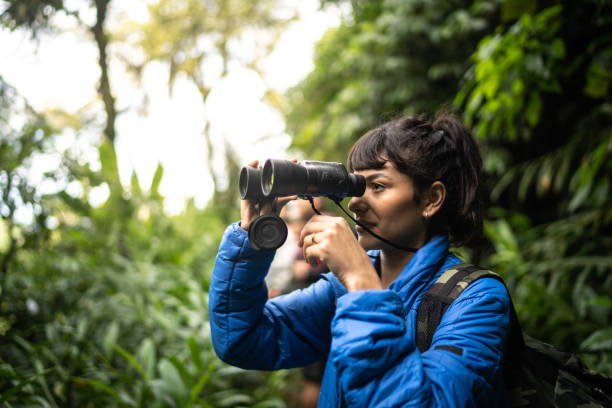 istock Young woman usng binoculars during hiking 1316244211
