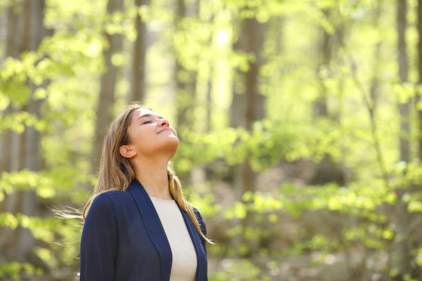 istock Relaxed woman breaths fresh air in a forest 1316244503
