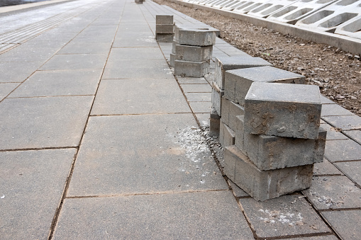 Stack of bricks on the sidewalk. Pavement renewal project in the city.