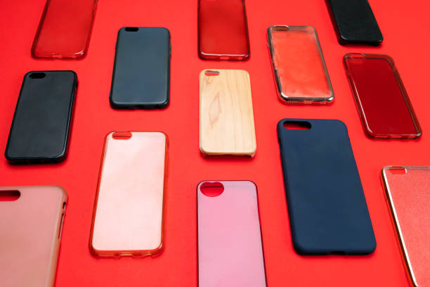 istock Pile of multicolored plastic back covers for mobile phone. Choice of smart phone protector accessories on red background. A lot of silicone phone backs or skins next to each other 1316244838