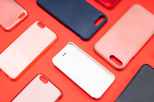istock Pile of multicolored plastic back covers for mobile phone. Choice of smart phone protector accessories on red background. A lot of silicone phone backs or skins next to each other 1316244848