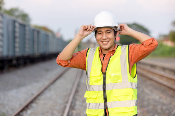 Portrait Engineer man working on railway. Chief Engineer in the Hard Hat in maintenance facility, Engineer and repair man concept. Safety first