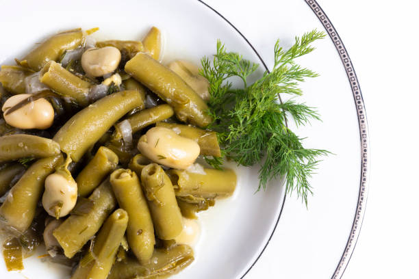 broad bean and dill in the white plate with white background. - broad bean imagens e fotografias de stock