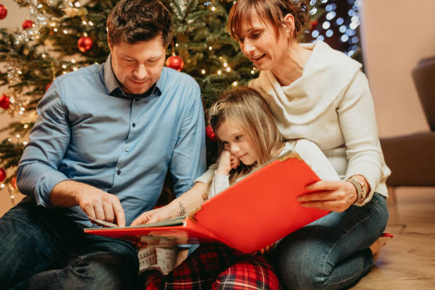istock Family reading story book during Christmas 1316247469