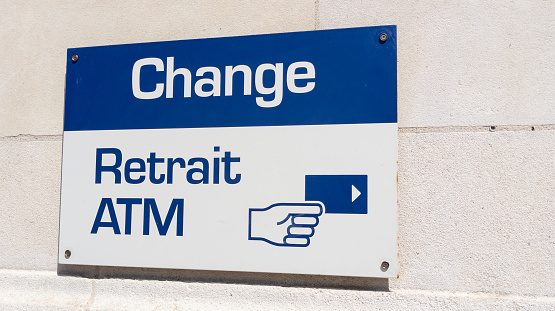 change retrait atm means in french exchange money office and square shape ATM sign in wall bank agency