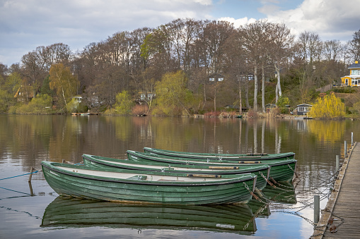 Row boats at the shore of Farum Lake, which is part of a system of large lakes north of Copenhagen. The boats belongs to a fishing club