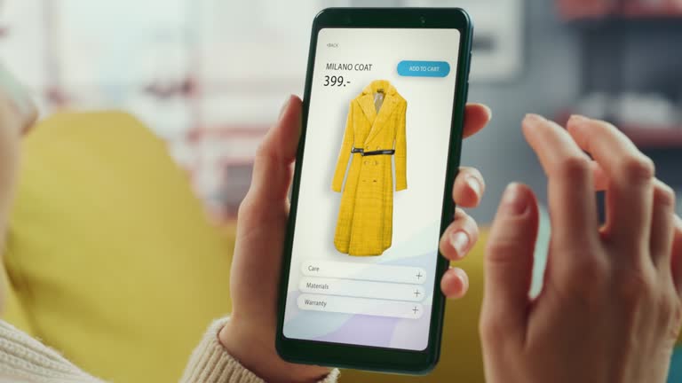 Beautiful Authentic Female Online Shopping on Her Smartphone at Home Living Room while Lying on a Couch Sofa. She's Browsing the Internet and Checking Deals in Her Favourite Internet Clothing Store.