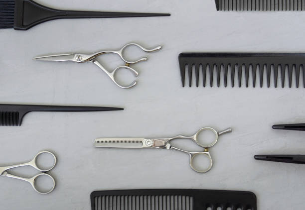 istock Full frame with hairdressing tools, combs, scissors on a gray background. Hair salon accessories, top view 1316253887