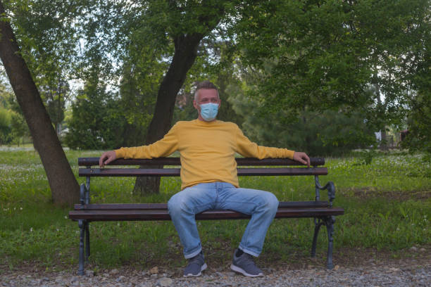 istock Adult man smiling behind protective face mask 1316254978