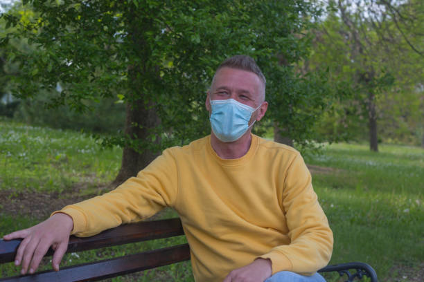 istock Adult man smiling behind protective face mask 1316255005