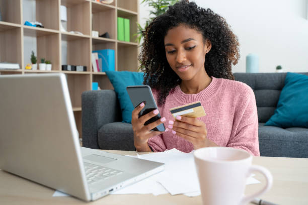 istock Black woman paying online purchase with a debit card 1316257730