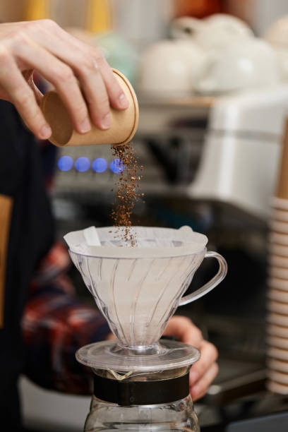 istock male hands pouring grounded coffee in filter. 1316260333