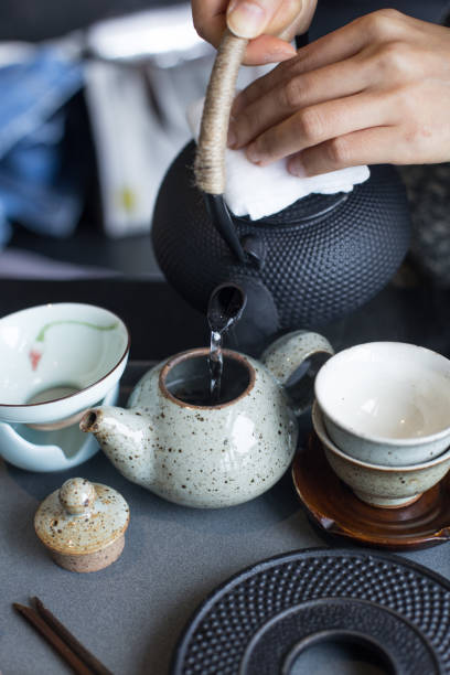 istock Women's hands pour hot drinks in the cup. 1316260572