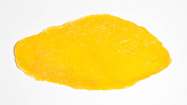 istock Yellow slice of dried mango on white background 1316260747