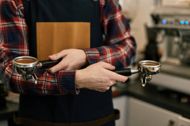 istock barista in apron grinding coffee in cafe 1316261146