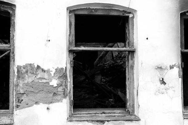 istock Wall with a window of an old destroyed burnt house. 1316262747