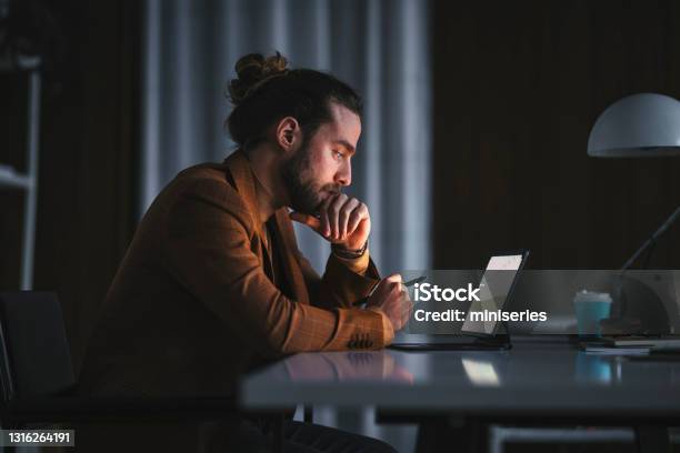 Pensive Man Working On Laptop In Office Stock Photo - Download Image Now - Men, Working, People