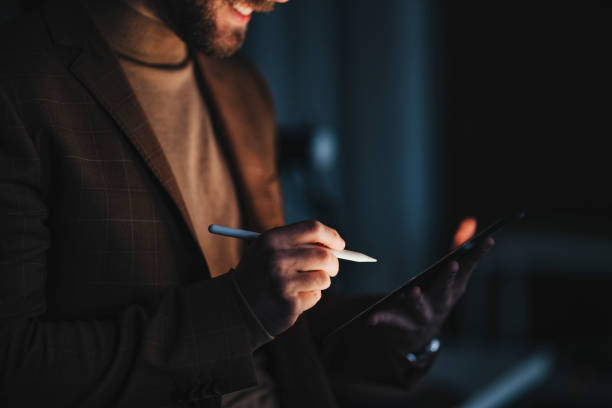 istock Unrecognizable happy designer sketching on tablet in darkness 1316264236