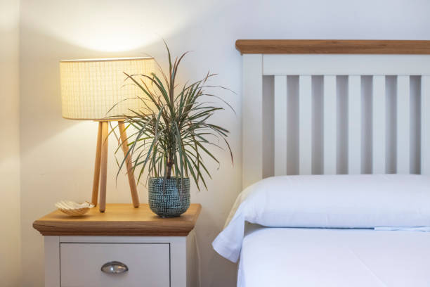 istock Opened book on wooden bedside table near crumpled bed 1316264788