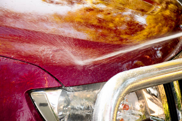 istock Washing a red car with high pressure washer cleaner. 1316266105