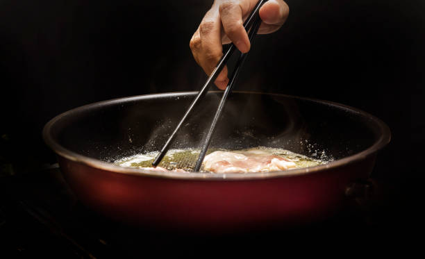istock coocking pork grill on hot electrict pan with chopstick  and butter smoke 1316267434