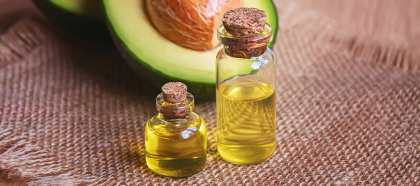 istock Avocado and avocado oil on wooden background. Selective focus. 1316267555