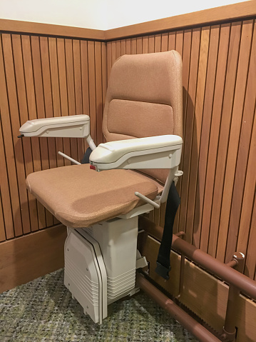 Shot of an automatic stairlift chair for disabled and elderly people installed in a residential building.